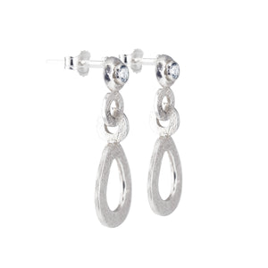 A side view image of the hand-textured silver dangle post earrings. 