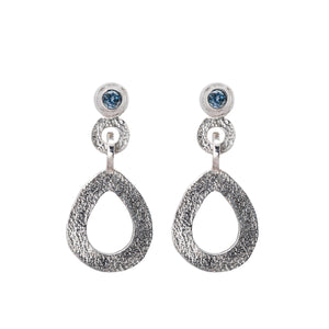These hand-textured silver dangle post earrings features 3mm denim blue Montana sapphires.
