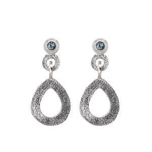 These hand-textured silver dangle post earrings features 3mm greenish-blue Montana sapphires.