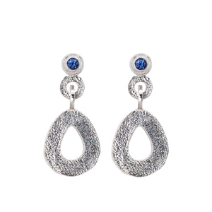 These hand-textured silver dangle post earrings features 3mm brilliant Ceylon blue sapphires. These teardrop dangles have a wider base to make a statement. 