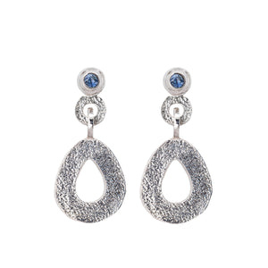 These hand-textured silver dangle post earrings features 3mm ocean blue Montana sapphires. These teardrop dangles have a wider base to make a statement. 